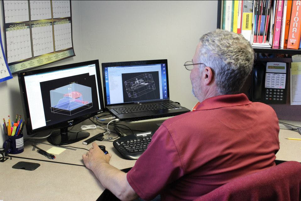 Worker at computer working on ECN